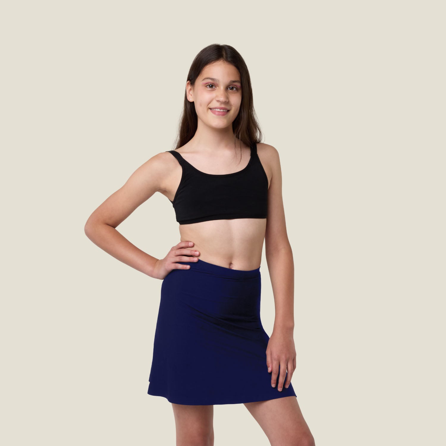 Teen wearing WUKA Teen Stretch Seamless Skort in navy — heavy flow period skort designed for confidence and comfort.