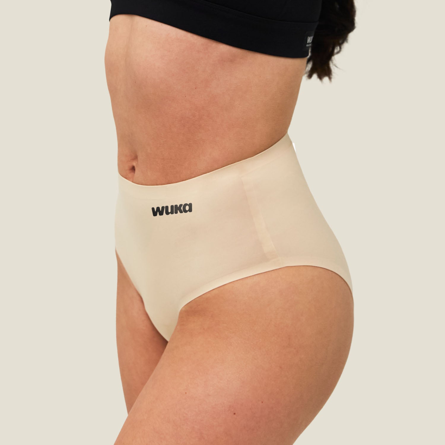 Side profile of WUKA Teen Stretch Seamless Midi Brief for heavy periods in Light Nude, showing smooth and seamless finish.
