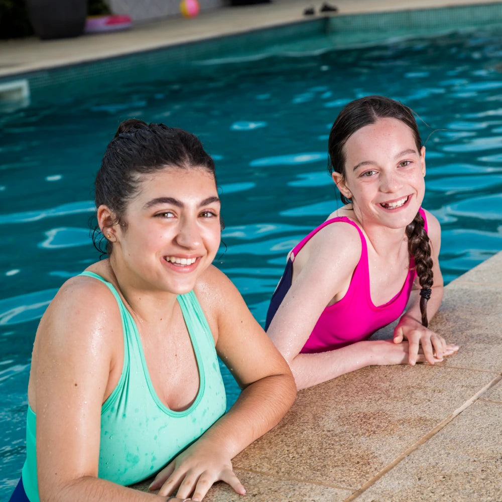 Young swimmers from Hatfield Swimming Club in a pool, highlighting the WUKA partnership supporting girls to swim confidently during their periods